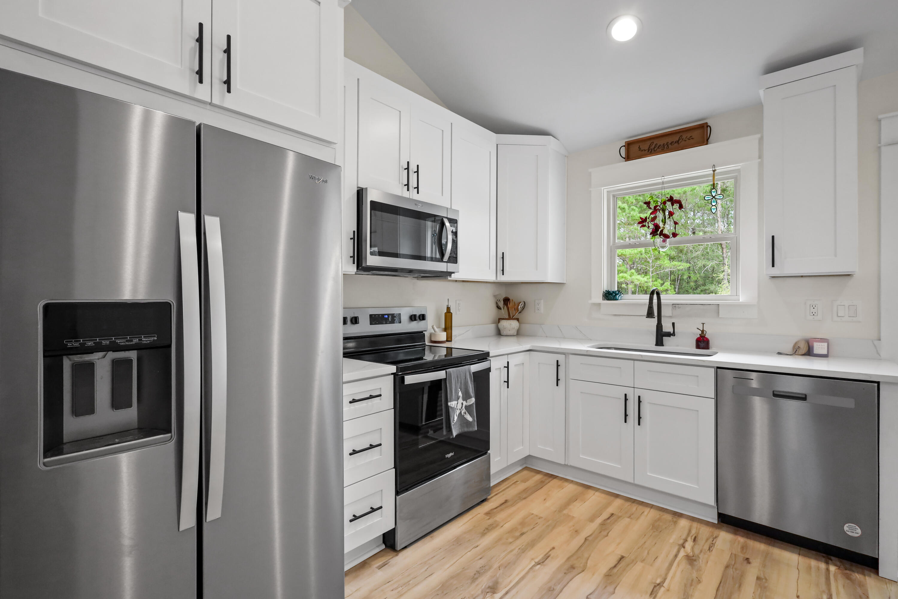 71 Lafavre Lane DeFuniak Springs, FL 32433 - Photo 4 of 32 a kitchen with stainless steel appliances a refrigerator stove and sink