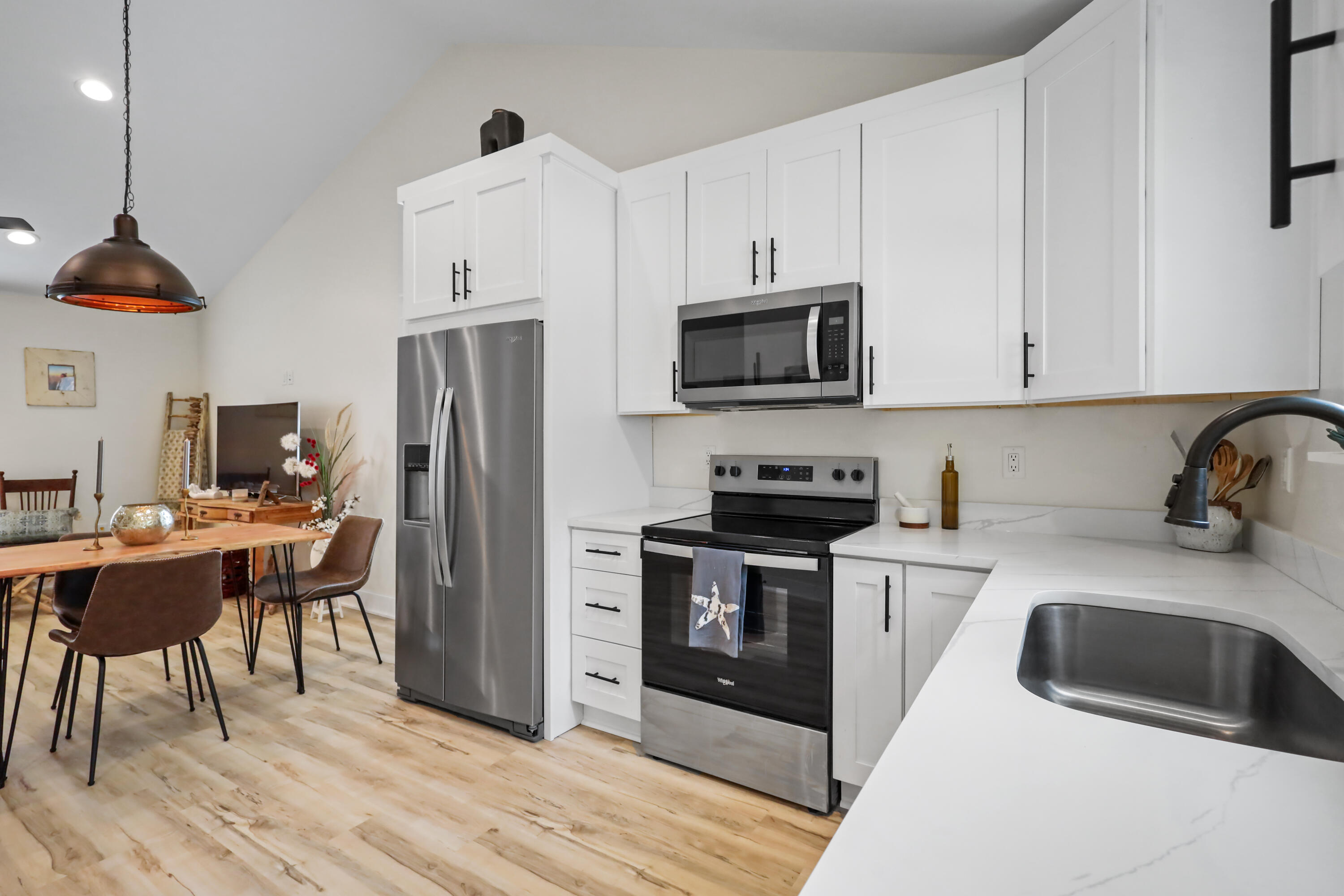 71 Lafavre Lane DeFuniak Springs, FL 32433 - Photo 5 of 32 a kitchen with stainless steel appliances a stove a sink a refrigerator and cabinets