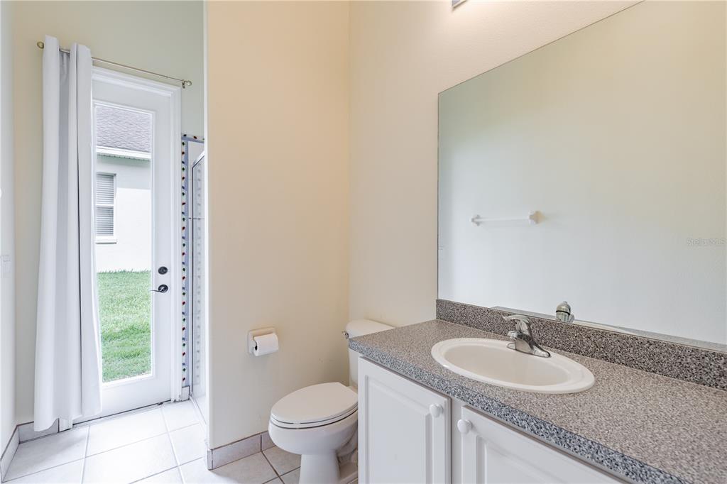 2718 Knightsbridge Road Clermont, FL 34711 - Photo 25 of 72 a bathroom with a granite countertop sink and a toilet