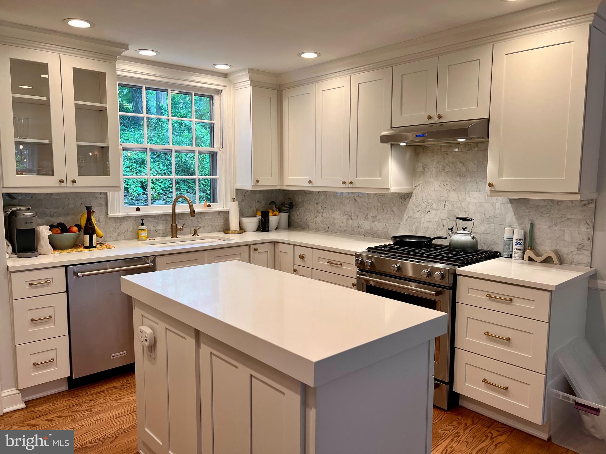 112 Hilltop Road Philadelphia, PA 19118 - Photo 6 of 13 a kitchen with a stove sink and cabinets