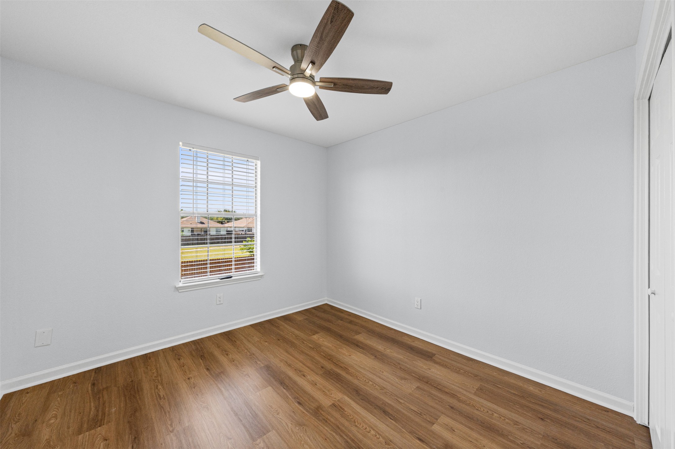 243 Engineers Pass Jarrell, TX 76537 - Photo 30 of 40 Interior room featuring wood-finish flooring, light-toned walls, and a ceiling fan with integrated lighting