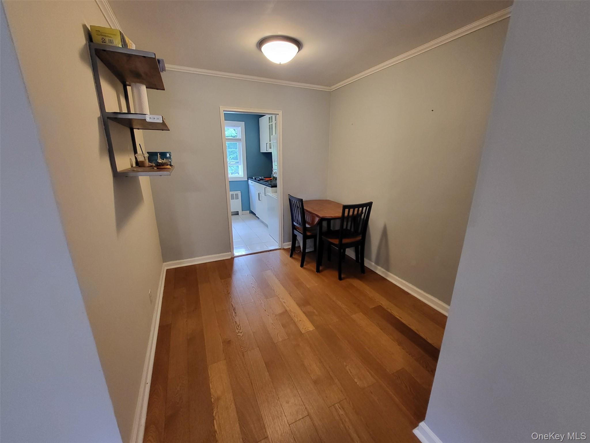 224-23 Kingsbury Avenue, Unit B Queens, NY 11364 - Photo 13 of 22 Dining area featuring wood-type flooring and ornamental molding