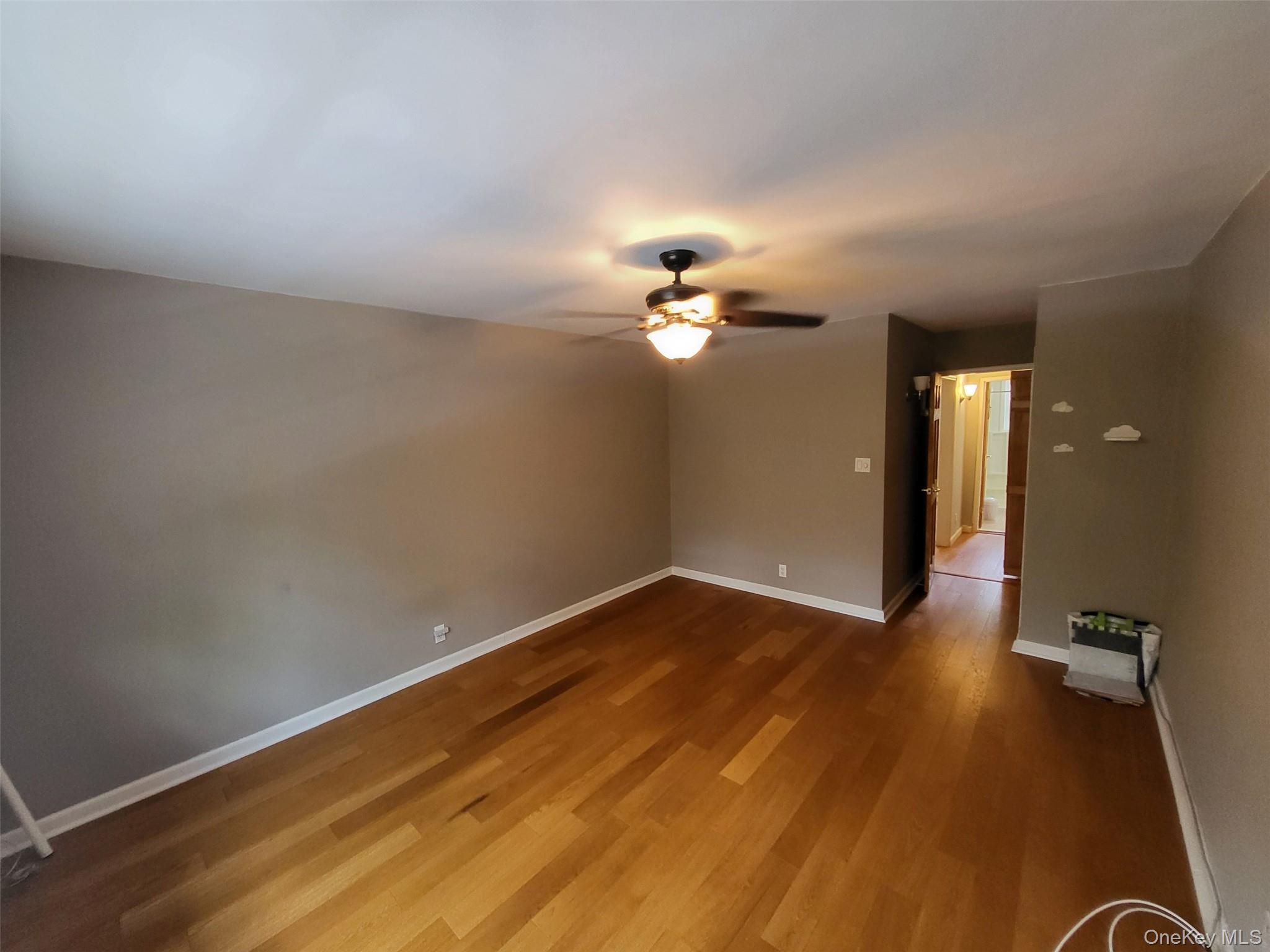 224-23 Kingsbury Avenue, Unit B Queens, NY 11364 - Photo 10 of 22 Empty room featuring ceiling fan and wood finished floors