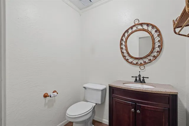 a bathroom with a toilet a sink and a mirror