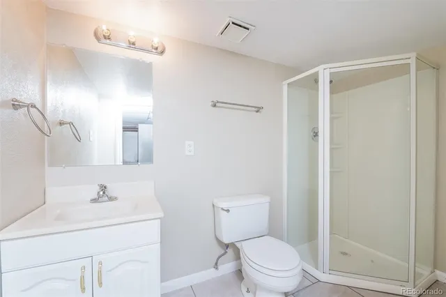 a bathroom with a sink toilet vanity and shower