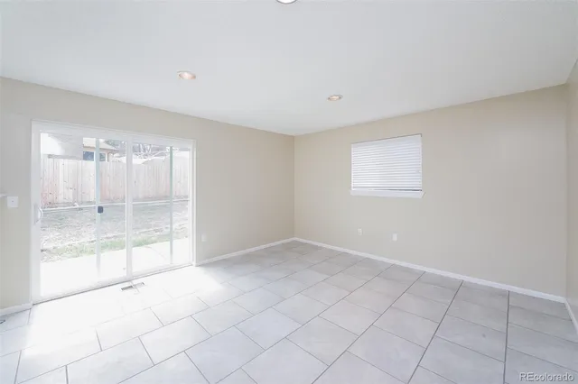 a view of an empty room with glass door
