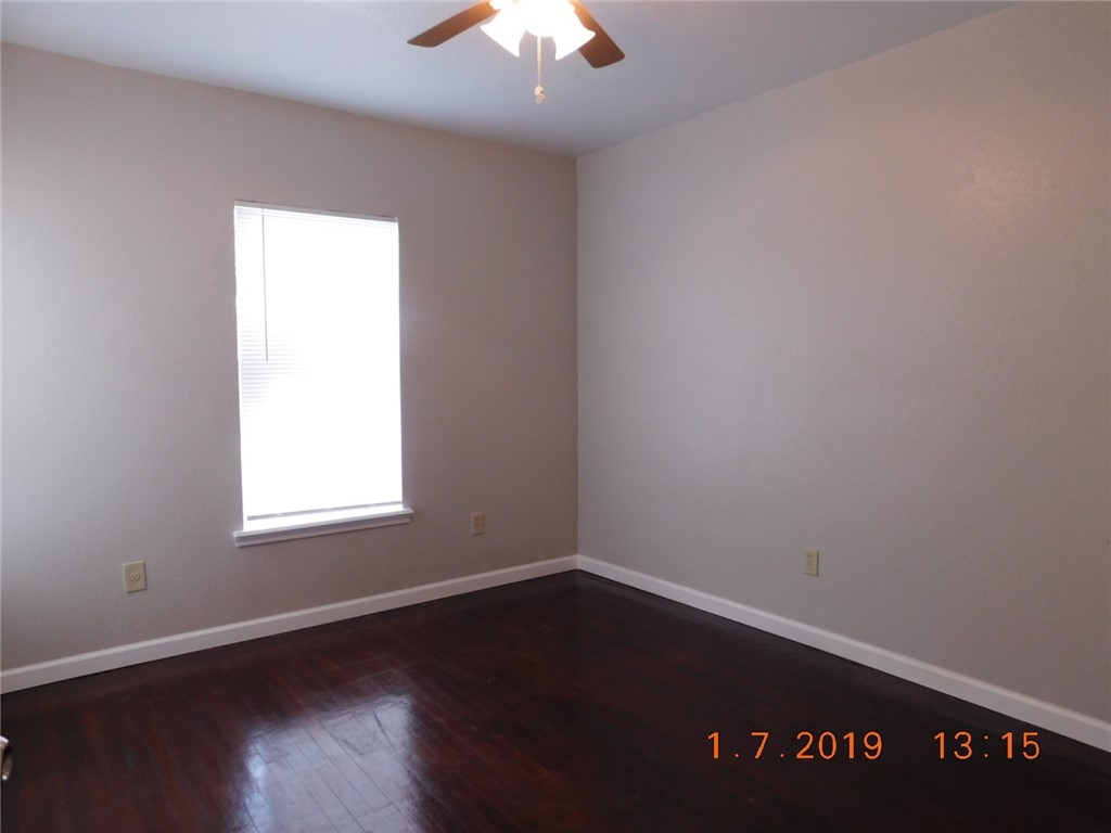 2625 Riggan Street Corpus Christi, TX 78404 - Photo 6 of 7 an empty room with wooden floor and windows