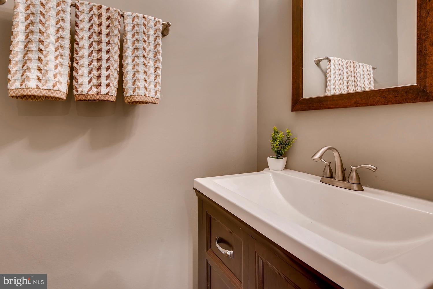 2612 Talbot Road Baltimore, MD 21216 - Photo 14 of 33 a bathroom with a sink and a mirror