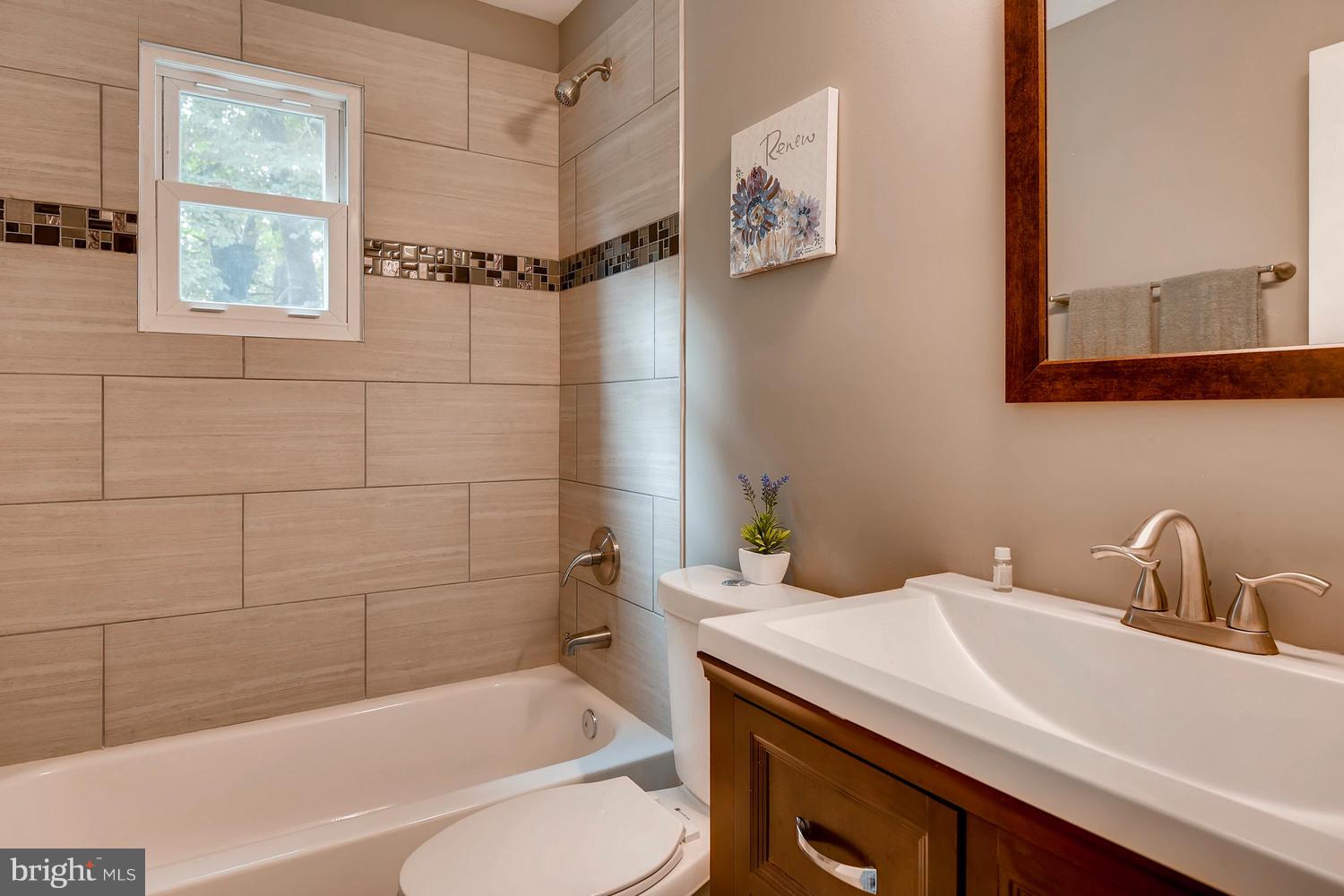 2612 Talbot Road Baltimore, MD 21216 - Photo 22 of 33 a bathroom with a sink a toilet and shower