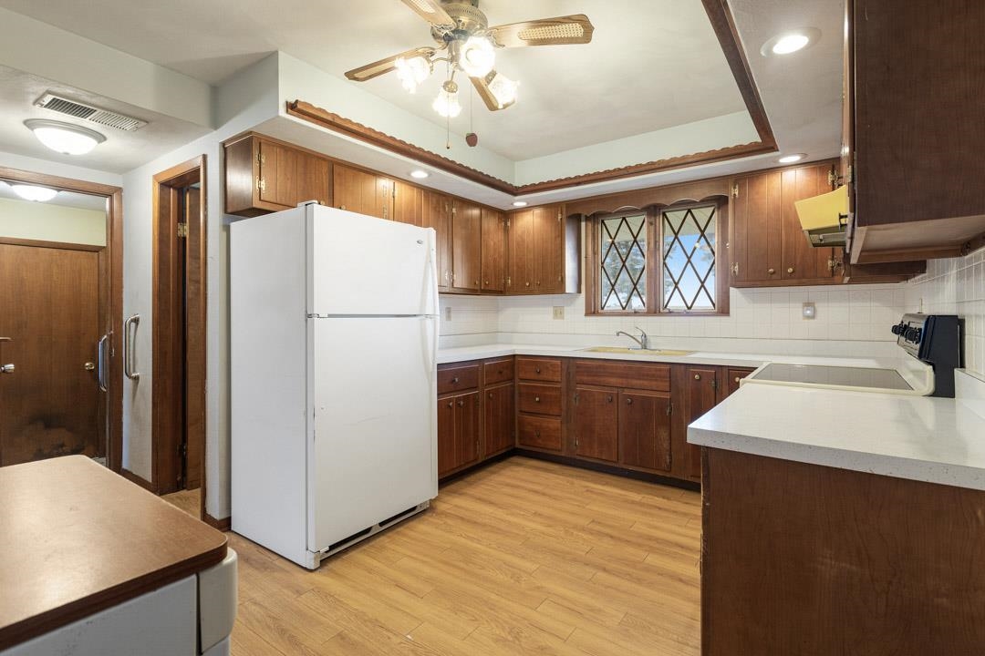 5618 North Armour Road Stillman Valley, IL 61084 - Photo 11 of 29 a kitchen with a sink a refrigerator and a sink