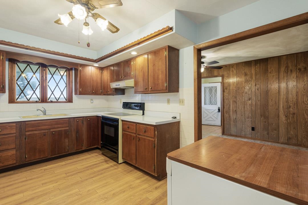 5618 North Armour Road Stillman Valley, IL 61084 - Photo 12 of 29 a kitchen with wooden cabinets and window