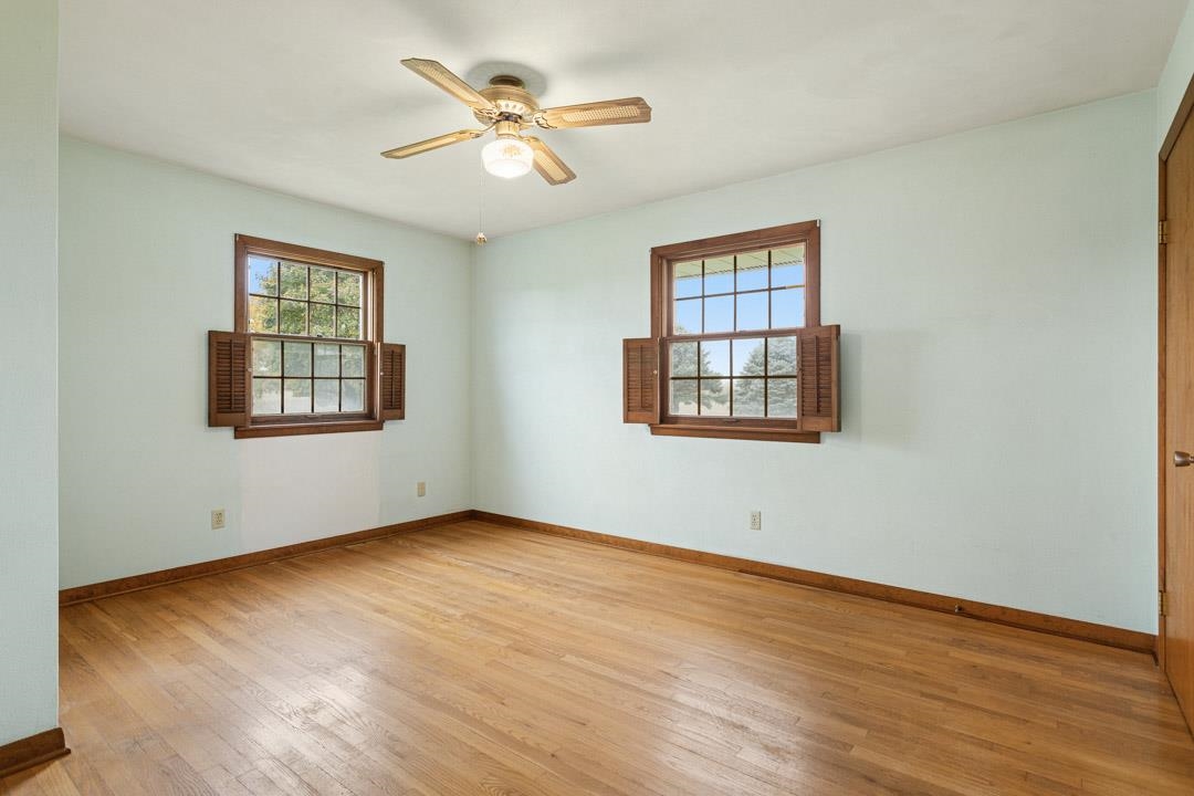 5618 North Armour Road Stillman Valley, IL 61084 - Photo 16 of 29 an empty room with wooden floor chandelier and windows