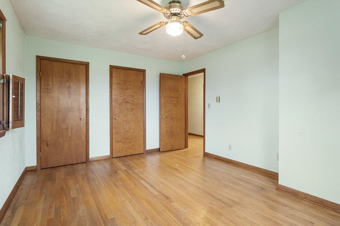 5618 North Armour Road Stillman Valley, IL 61084 - Photo 17 of 29 a view of an empty room with wooden floor and a ceiling fan