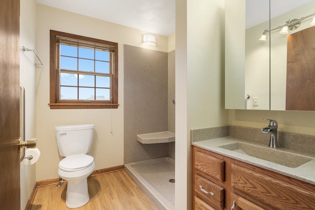 5618 North Armour Road Stillman Valley, IL 61084 - Photo 19 of 29 a bathroom with a granite countertop toilet a sink and a mirror