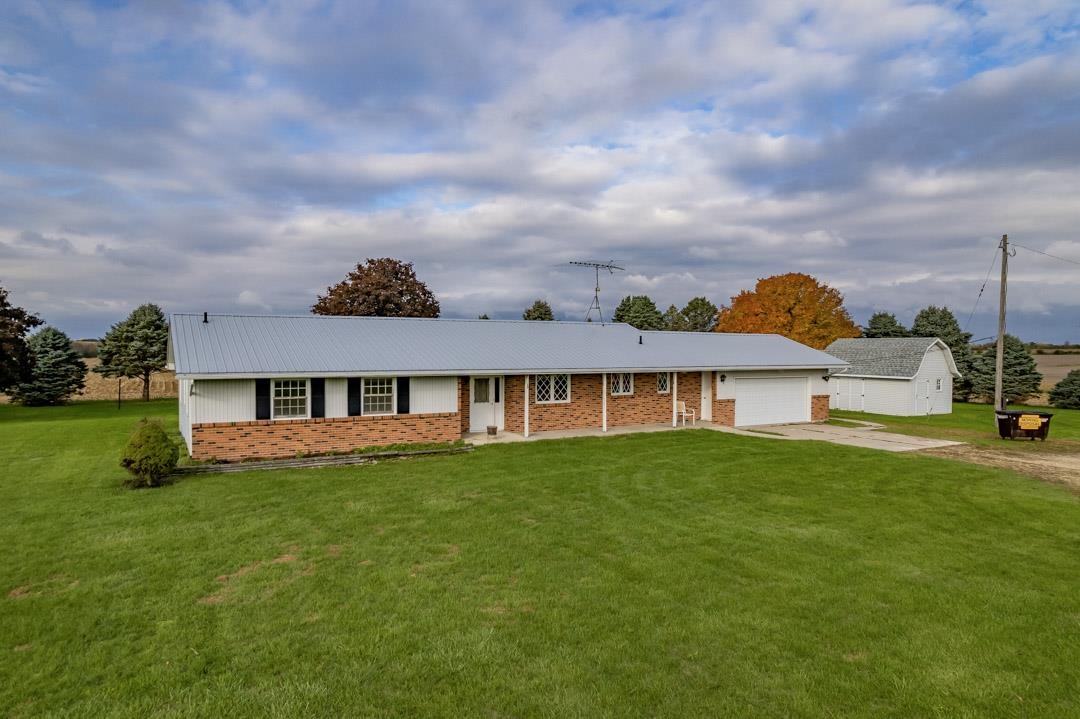 5618 North Armour Road Stillman Valley, IL 61084 - Photo 2 of 29 a view of a house with a big yard potted plants and large tree