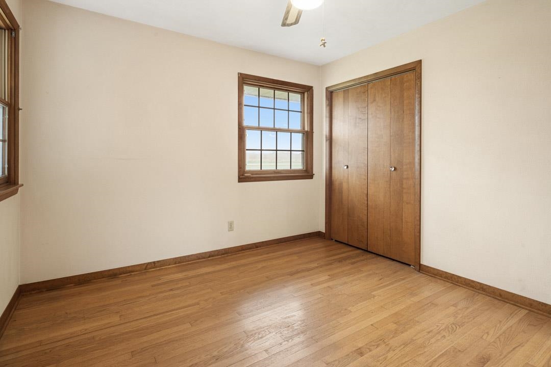 5618 North Armour Road Stillman Valley, IL 61084 - Photo 22 of 29 an empty room with wooden floor and windows