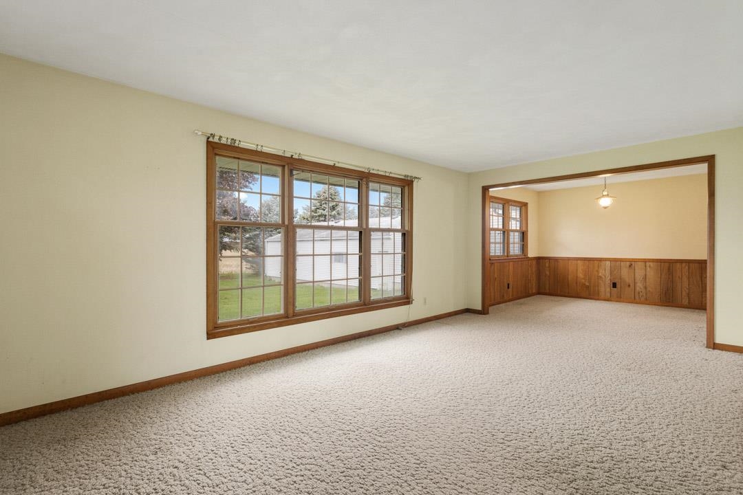5618 North Armour Road Stillman Valley, IL 61084 - Photo 3 of 29 an empty room with a fireplace and large window