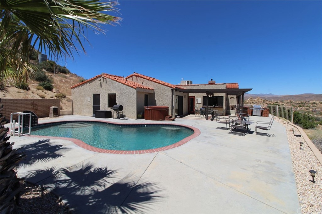55411 Skyline Ranch Road Yucca Valley, CA 92284 - Photo 1 of 1 a view of a house with pool and sitting area