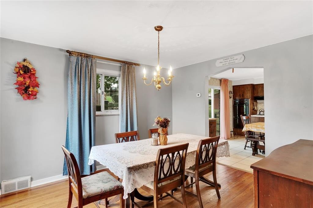 117 Diebold Road McKees Rocks, PA 15136 - Photo 12 of 22 a dining room with furniture a chandelier and wooden floor