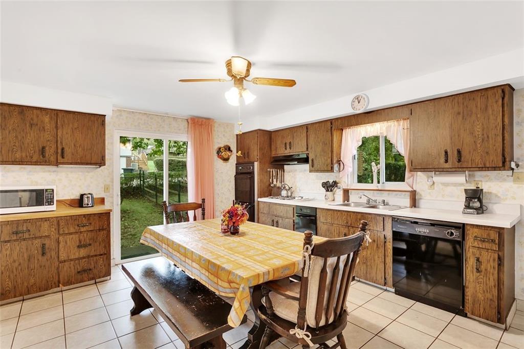 117 Diebold Road McKees Rocks, PA 15136 - Photo 14 of 22 a kitchen with a stove a sink a dining table and chairs