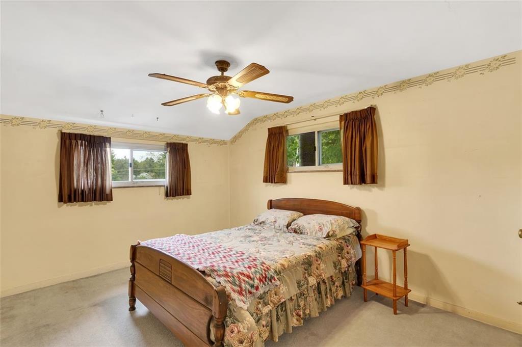 117 Diebold Road McKees Rocks, PA 15136 - Photo 17 of 22 a bedroom with a bed ceiling fan and a window
