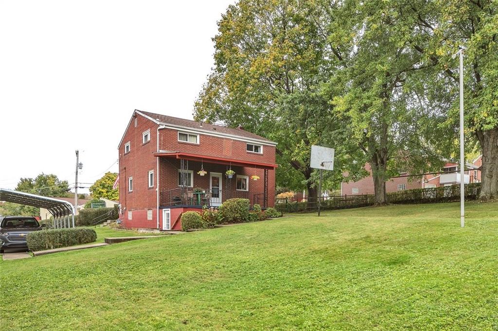 117 Diebold Road McKees Rocks, PA 15136 - Photo 4 of 22 a view of a house with a big yard and large trees