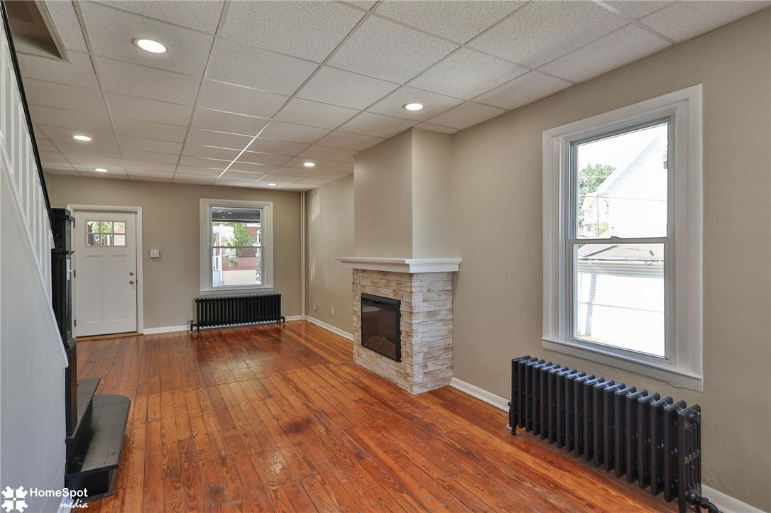 619 Sioux Street Bethlehem, PA 18015 - Photo 16 of 61 an empty room with windows fireplace and wooden floor