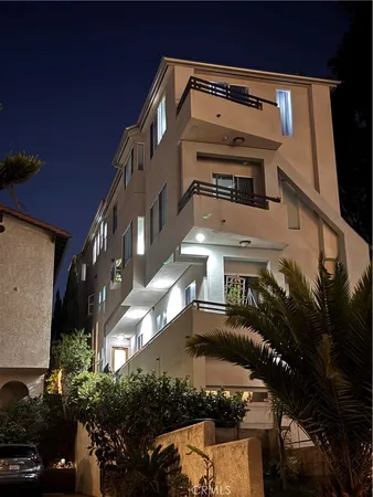 a view of building along with stairs and car parked