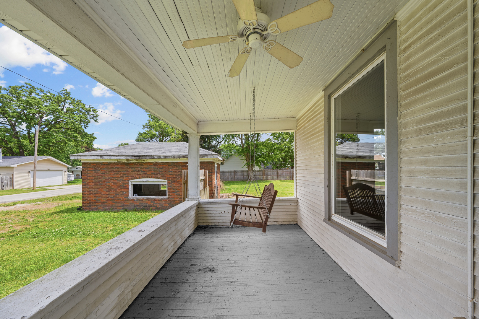 1202 20th Avenue Viola, IL 61486 - Photo 13 of 50 a view of a patio with a table and chairs under an umbrella