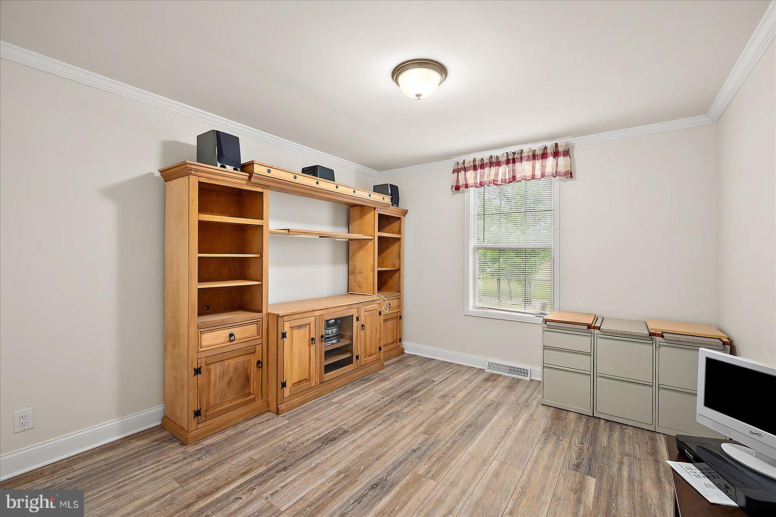 8225 Whitesville Road Pittsville, MD 21850 - Photo 18 of 45 a view of a bedroom with furniture and wooden floor