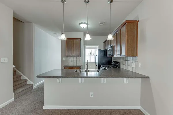 a view of a kitchen with a sink and mirror