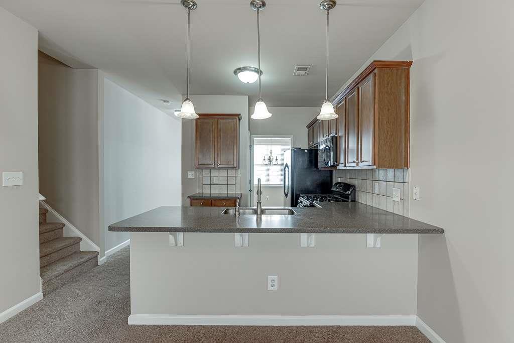 1043 Nightfall Court Northwest Suwanee, GA 30024 - Photo 11 of 39 a view of a kitchen with a sink and mirror