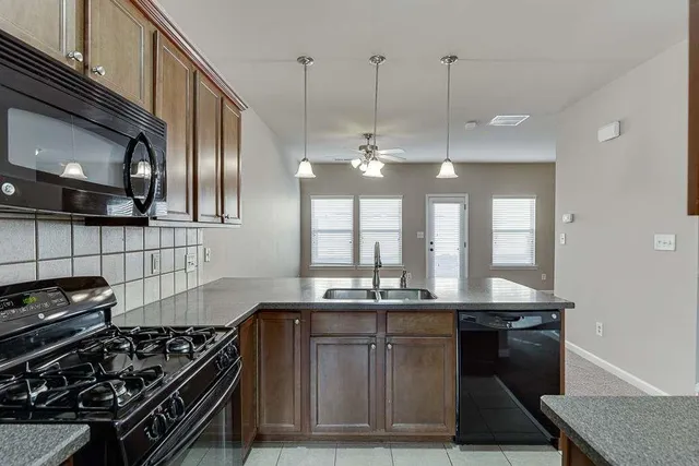 a kitchen with a stove and a refrigerator