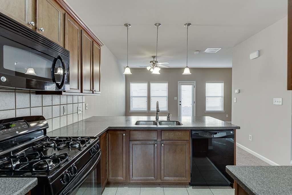 1043 Nightfall Court Northwest Suwanee, GA 30024 - Photo 12 of 39 a kitchen with a stove and a refrigerator