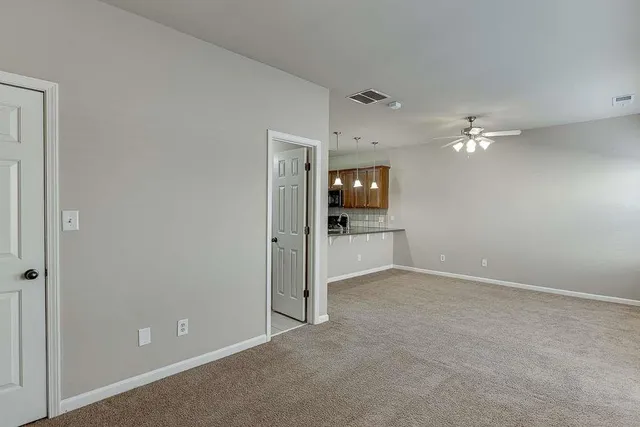 a view of an empty room with a bathroom
