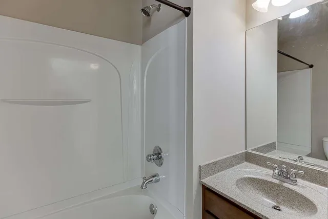 a bathroom with a shower and a bath tub