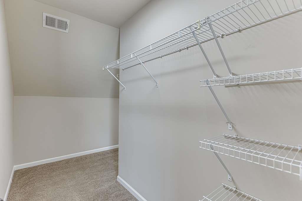 1043 Nightfall Court Northwest Suwanee, GA 30024 - Photo 28 of 39 a view of a room with racks on the wall