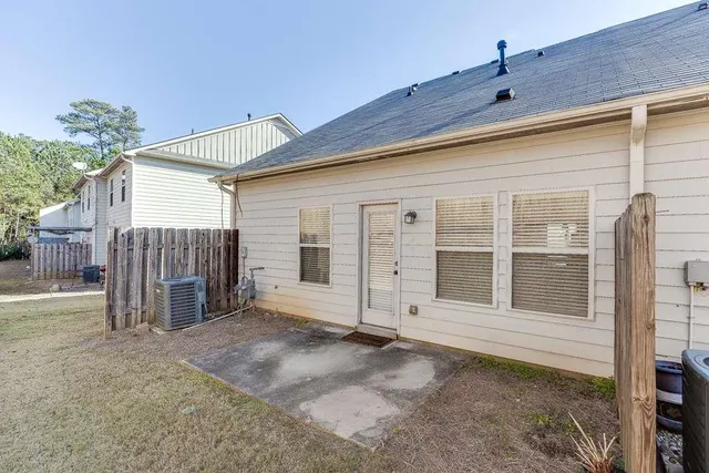 a view of a house with wooden fence