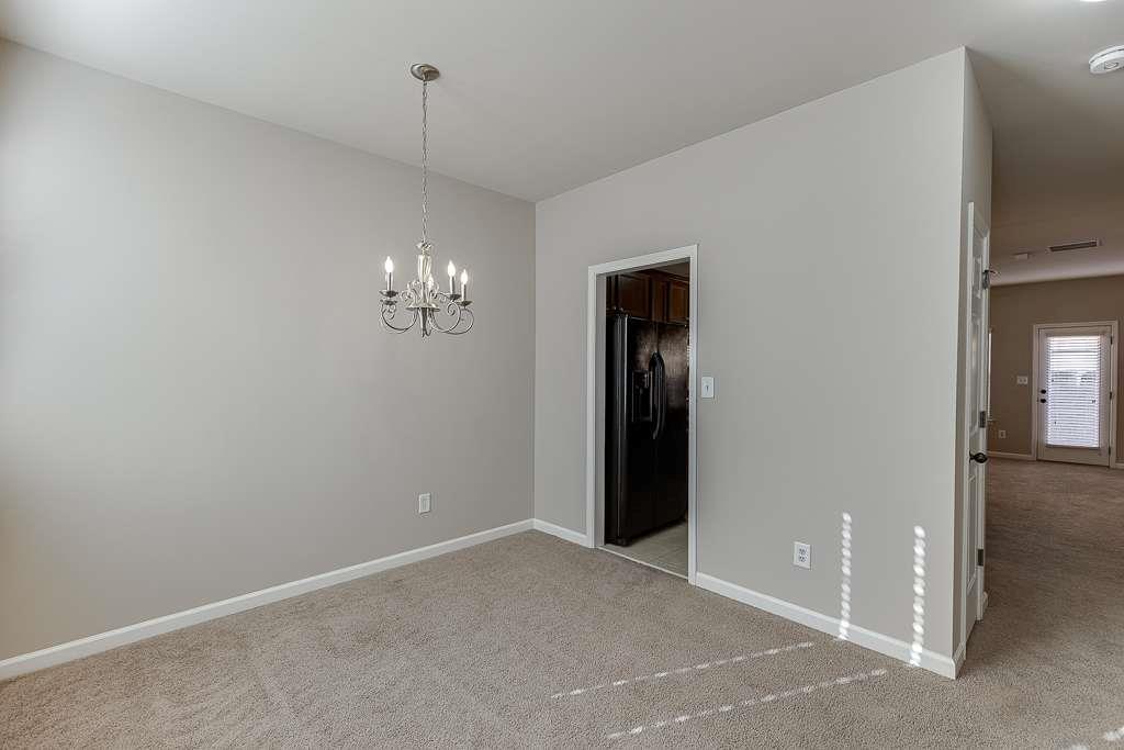 1043 Nightfall Court Northwest Suwanee, GA 30024 - Photo 5 of 39 a view of an empty room with a fan