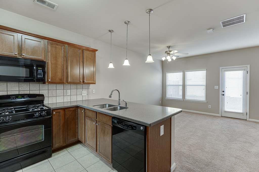 1043 Nightfall Court Northwest Suwanee, GA 30024 - Photo 8 of 39 a kitchen that has a sink a stove and cabinets