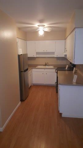 239 Northway Park Road, Unit 12 Machesney Park, IL 61115 - Photo 6 of 18 a kitchen with a sink and cabinets