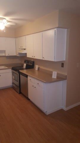 239 Northway Park Road, Unit 12 Machesney Park, IL 61115 - Photo 7 of 18 a kitchen with stainless steel appliances granite countertop a sink and a white cabinets