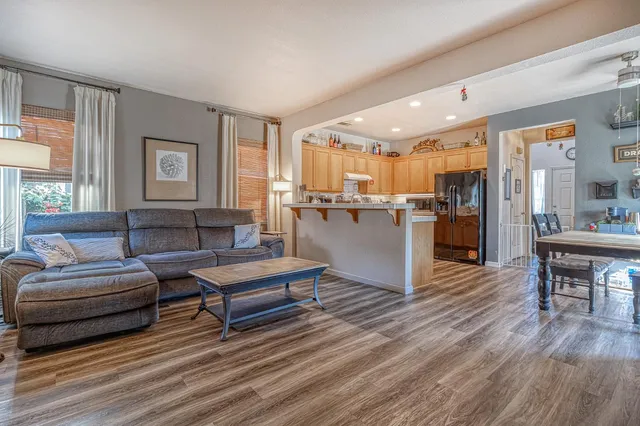 a living room with furniture and a kitchen view