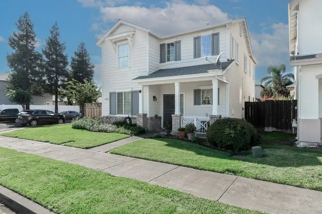 a front view of a house with a garden