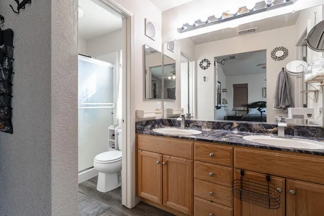 a view of a chair and table in backyard of the house