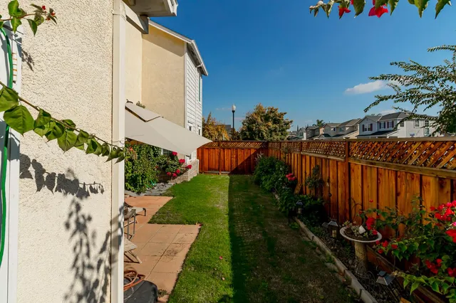 a wooden bench sitting in front of a house