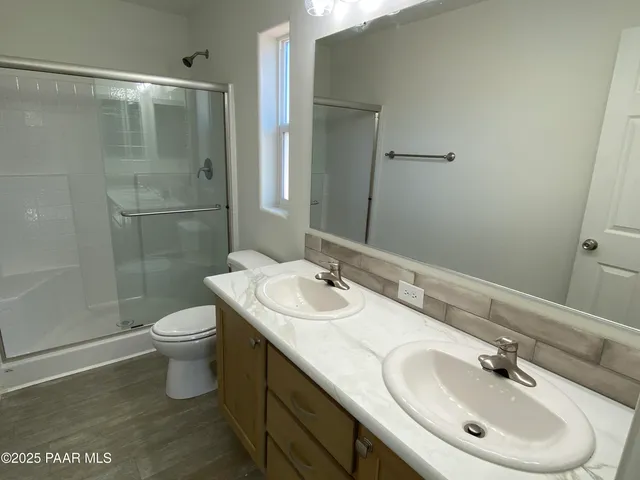 a view of a house with wooden fence