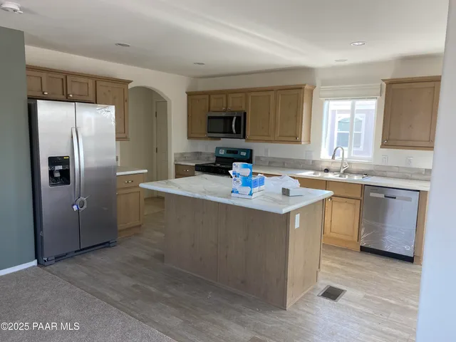 a kitchen with a refrigerator and a stove