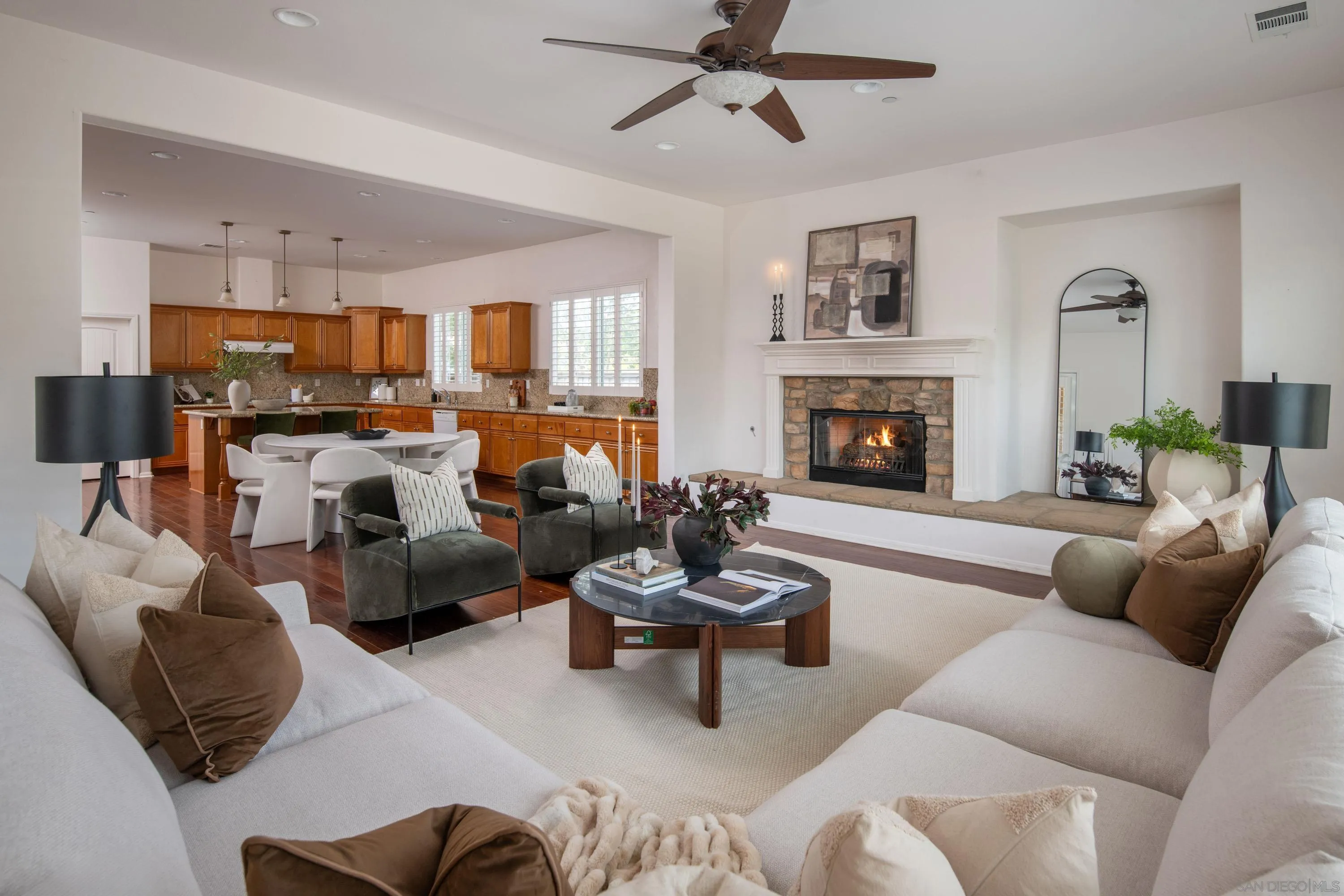 14220 Pebble Beach Way Valley Center, CA 92082 - Photo 1 of 48 a living room with furniture kitchen view and a fireplace