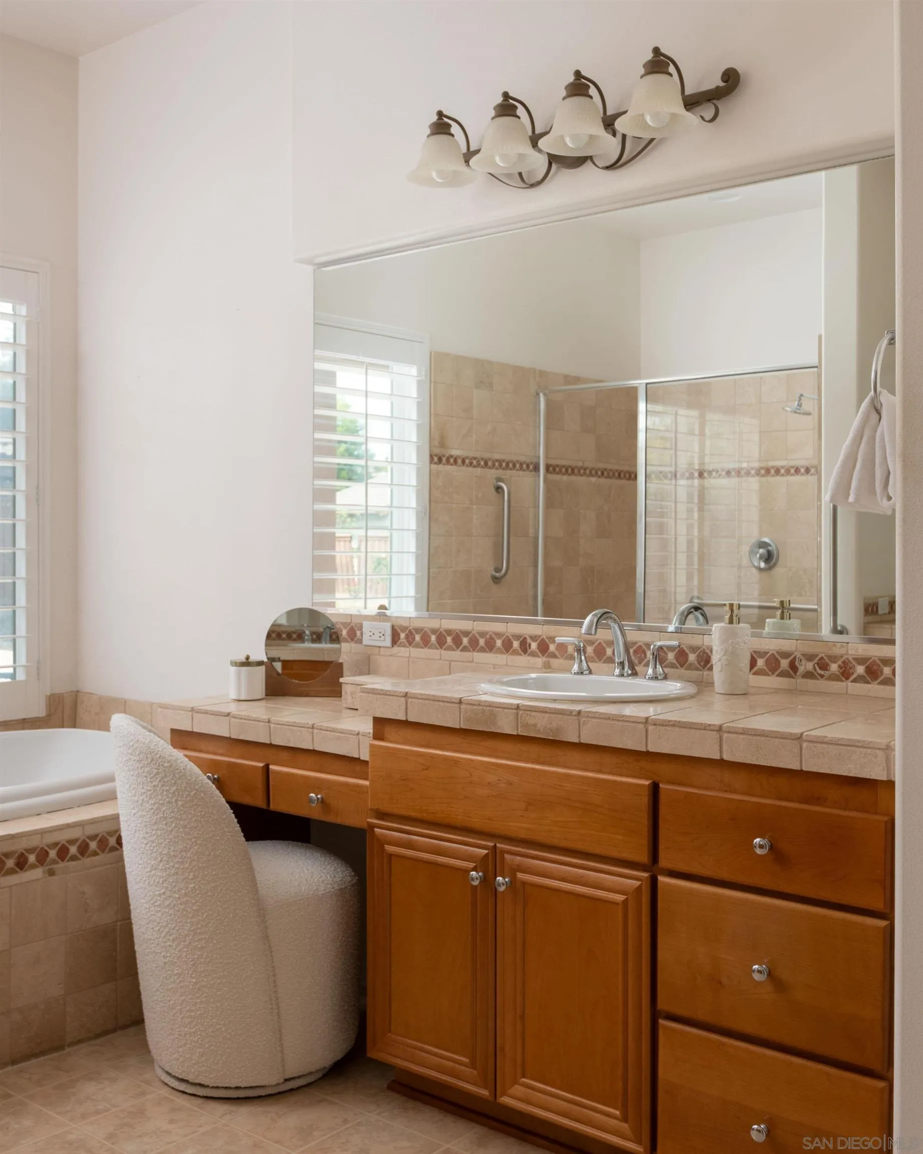 14220 Pebble Beach Way Valley Center, CA 92082 - Photo 24 of 48 a bathroom with a granite countertop sink a mirror and bathtub